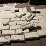 "Multiple white primed canvas pieces arranged in rows, showing the material preparation phase for the Samsaragammon art project."