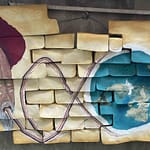 "Abstract artwork featuring vibrant patterns in multiple colors with circular motifs, representing the communication of consciousness through different vibrational frequencies."