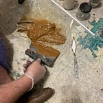 "Art supplies including beeswax, natural earth pigments, and oil paints used in creating the Samsaragammon artwork using traditional techniques."