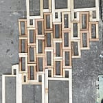 "Rectangular wooden frames arranged in a grid-like pattern, creating modular components for the Samsaragammon artwork that embody holographic interconnectedness."