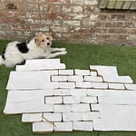 "Canvas pieces arranged on a grassy outdoor surface, laid out to check the collective arrangement of the Samsaragammon artwork components."